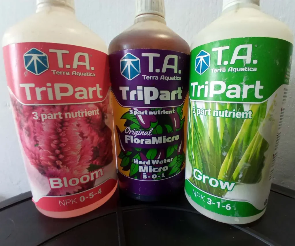 Three Terra Aquatica TriPart hydroponic nutrient bottles—Grow, Micro, and Bloom—used to provide balanced nutrition for plants at different growth stages.