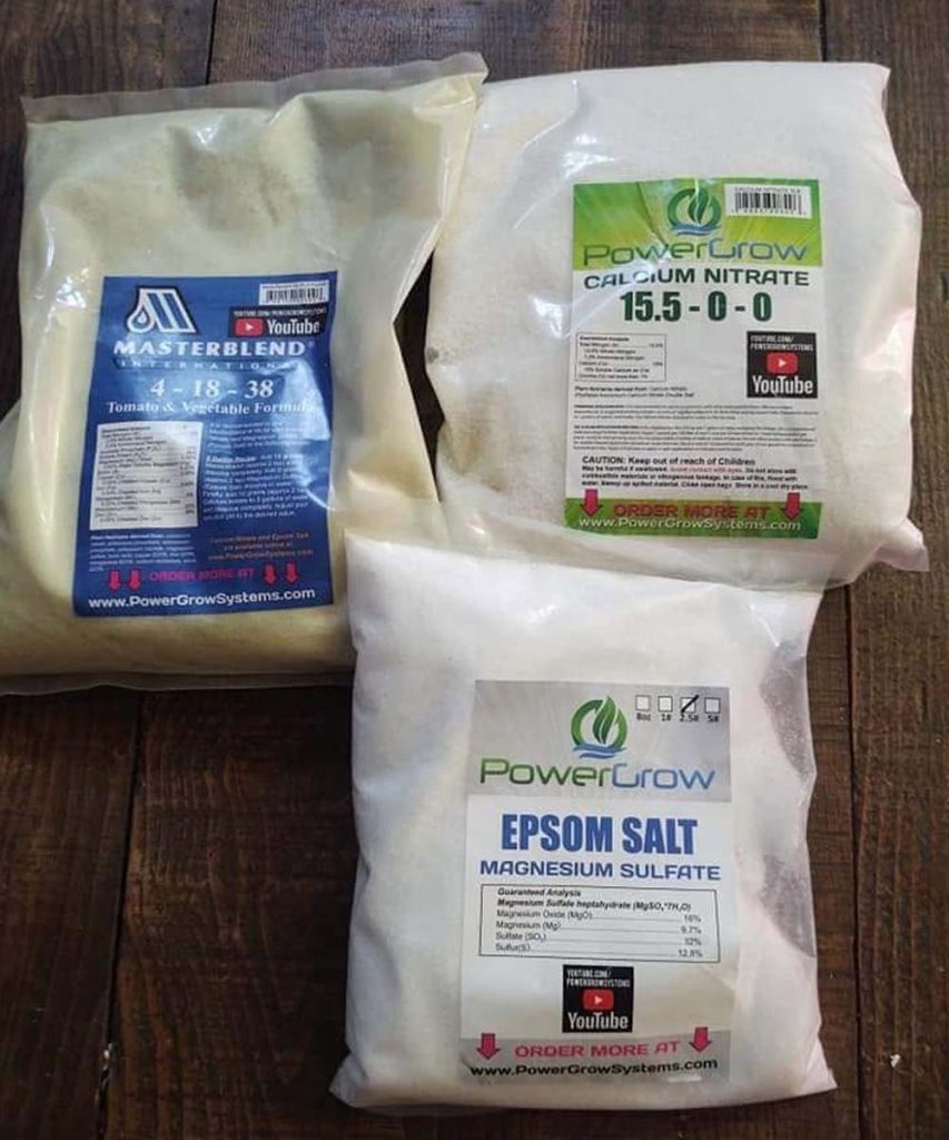 Three dry hydroponic fertilizer components—MasterBlend Tomato & Vegetable Formula, calcium nitrate, and Epsom salt—used to prepare custom nutrient solutions.