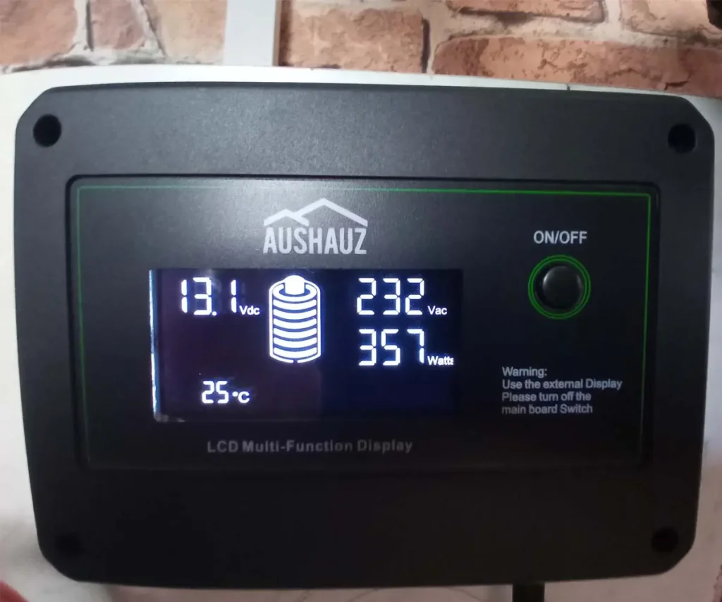 LCD power monitor displaying the electricity consumption of an indoor hydroponic garden, showing 357 watts of power draw