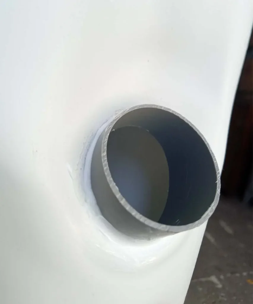 PVC sleeve glued into a hydroponic tower planting hole to create a stronger mounting point for the net pot.