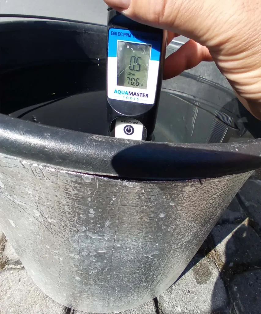 Hydroponic reservoir wrapped in reflective insulation with water temperature at 70.6°F